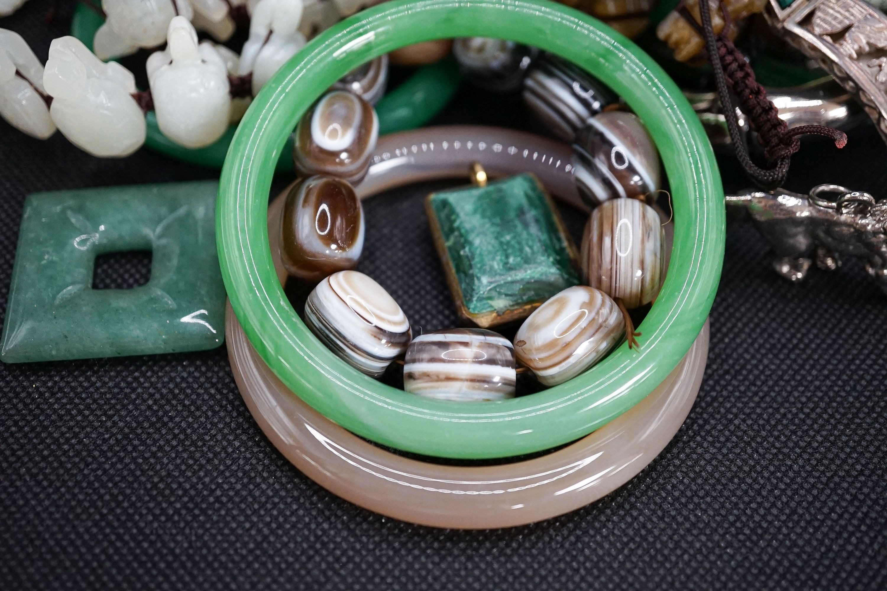 A group of bangles and necklaces including jade and agate.